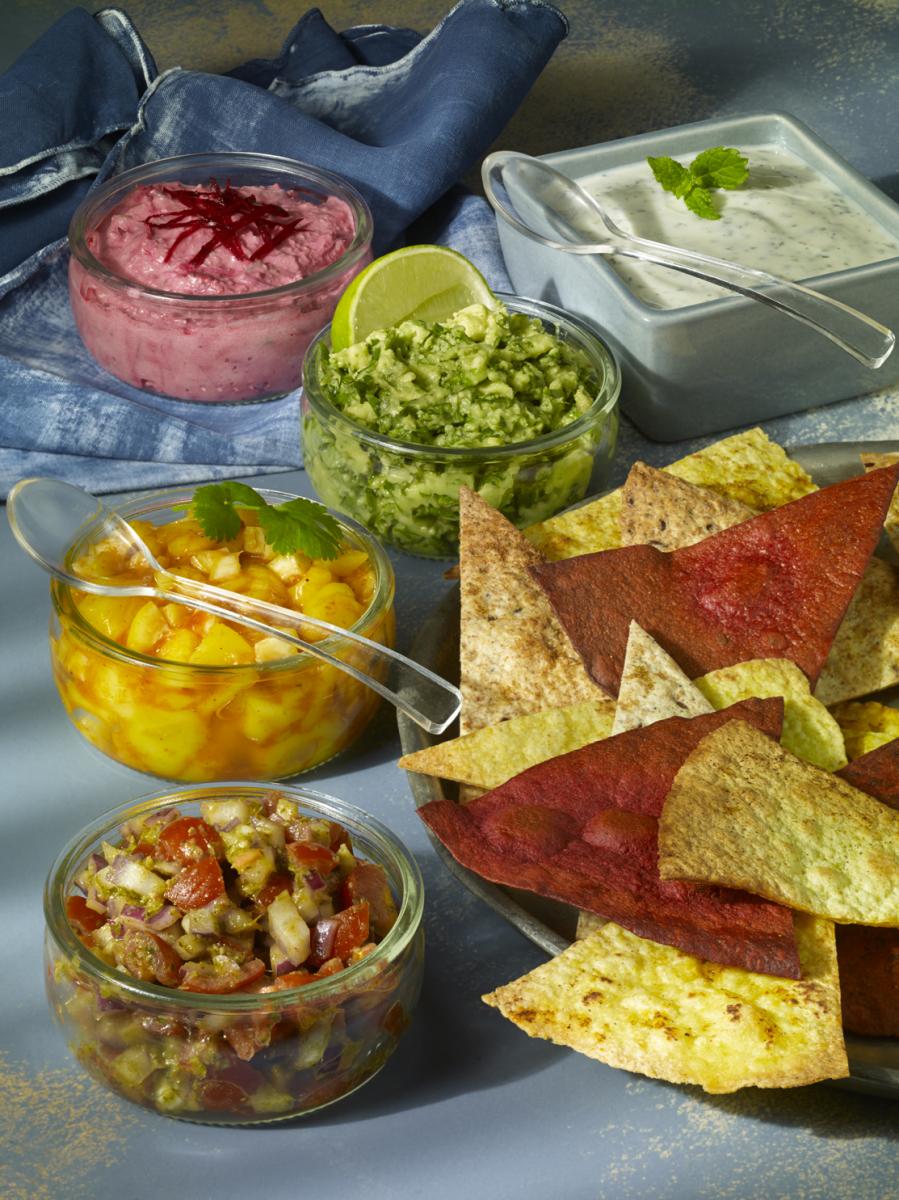 vegan tortilla chips with variety on dips
